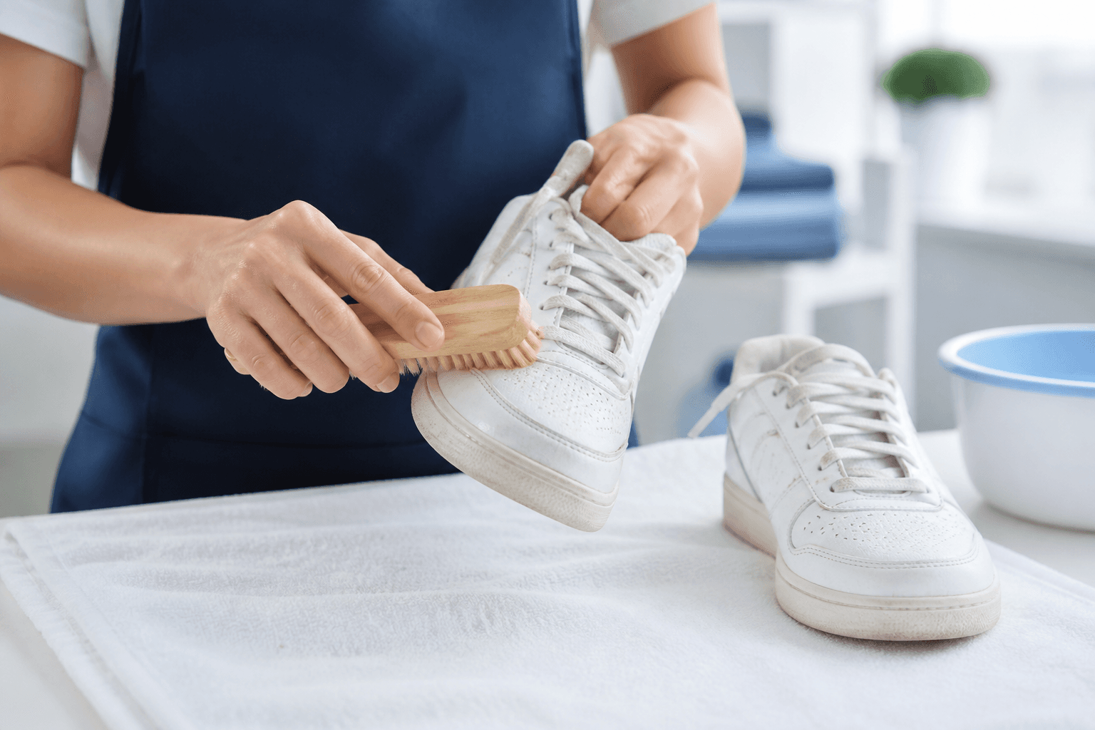 A pair of shoes being carefully brushed clean